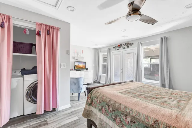 a bedroom with a bed and a chandelier