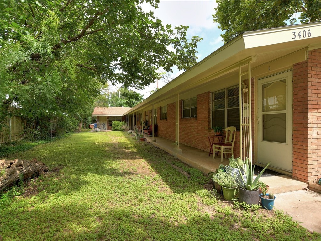 a view of a house with backyard and sitting area