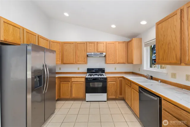 a kitchen with a stove sink and refrigerator