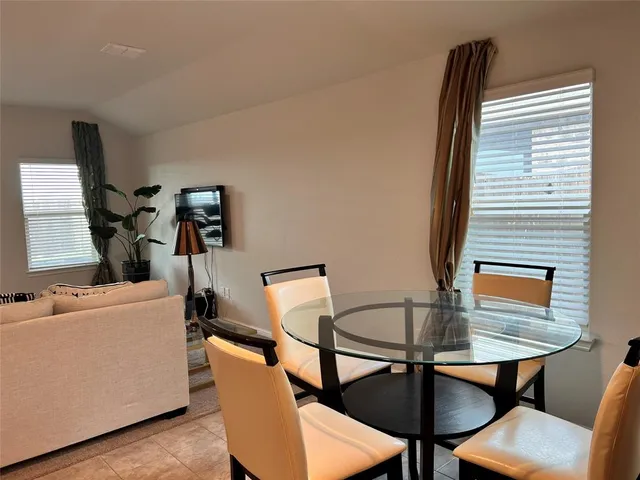 a view of a dining room with furniture and a window
