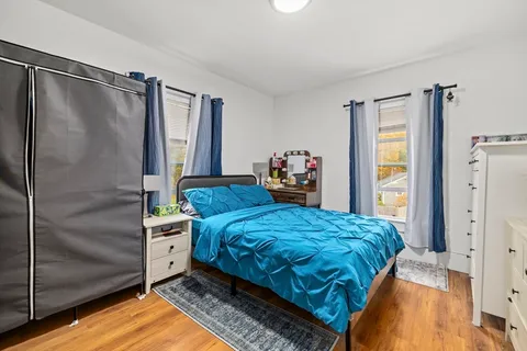 a bedroom with a bed and a dresser