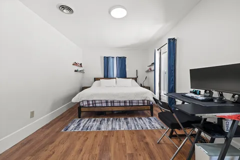 a spacious bedroom with a bed and a desk