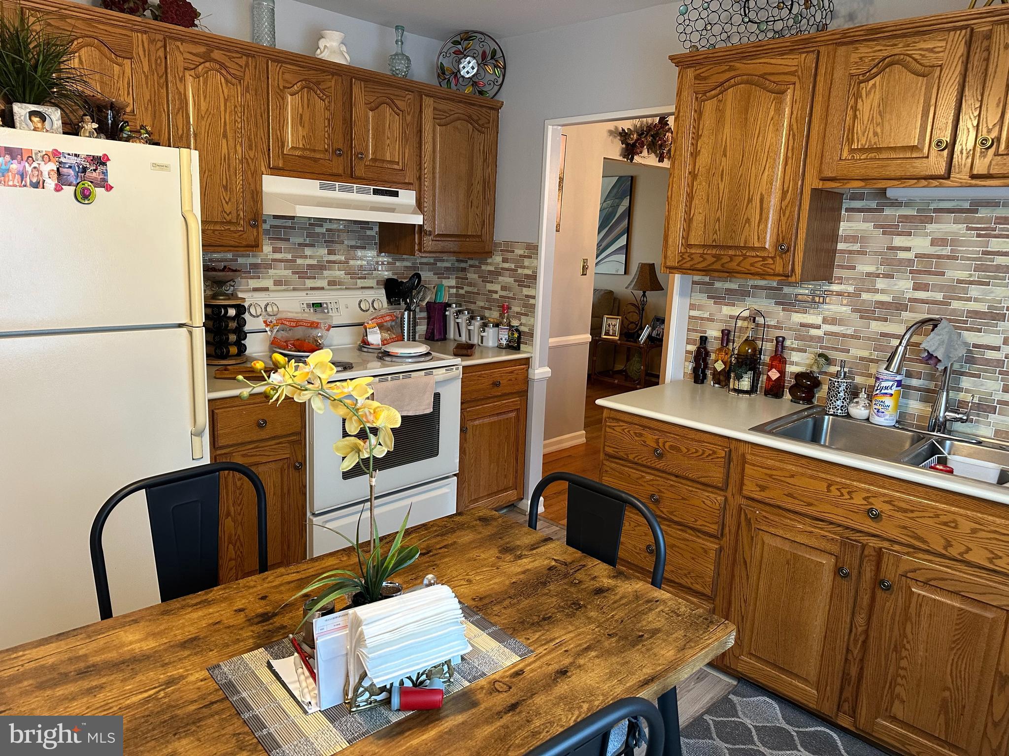 320 West Orvilla Road Hatfield, PA 19440 - Photo 12 of 46 a kitchen with stainless steel appliances granite countertop a refrigerator a stove a sink dishwasher and white cabinets with wooden floor