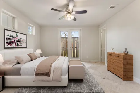 a bedroom with a bed and ceiling fan