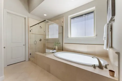 a bathroom with a granite countertop bathtub shower and vanity