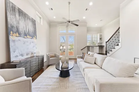 a living room with furniture a fireplace and a chandelier