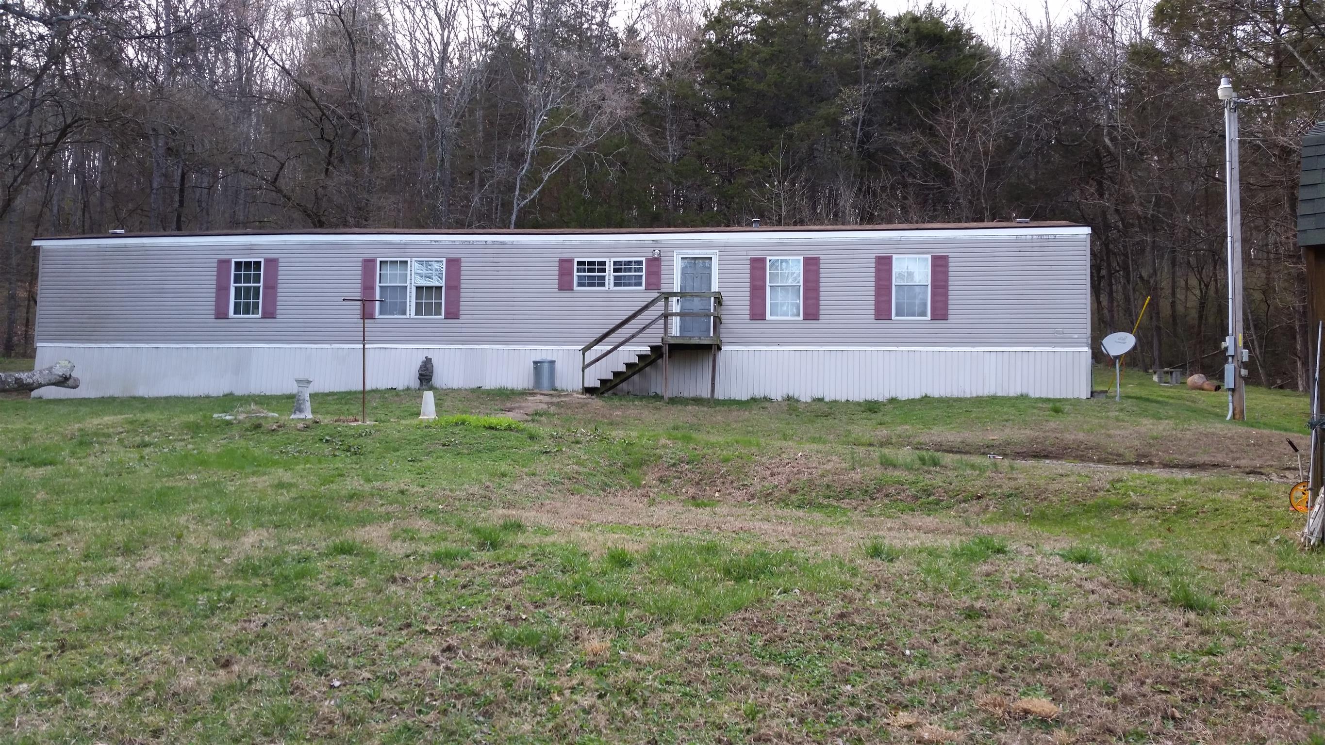 277 Hiwassee Road Lebanon, TN 37087 - Photo 1 of 15 a view of a yard in front of a house with large trees