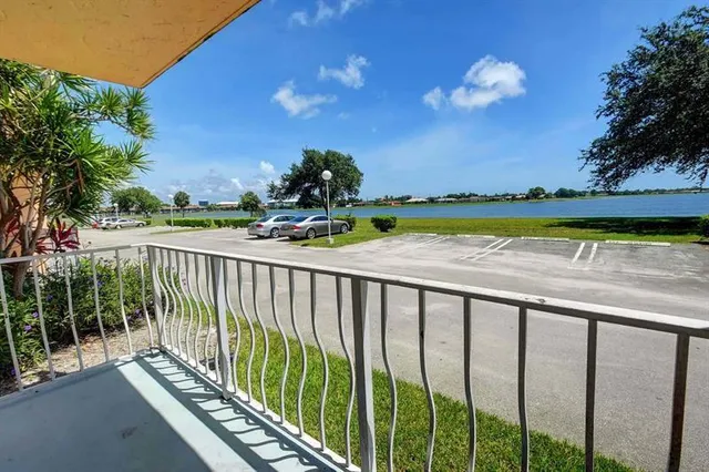 a view of balcony with wooden floor and lake view