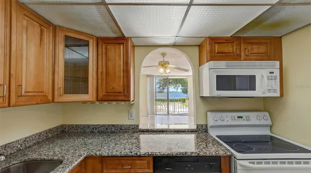 a kitchen with a sink a stove and cabinets