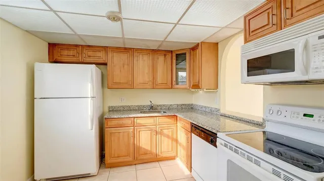 a kitchen with a refrigerator and a sink