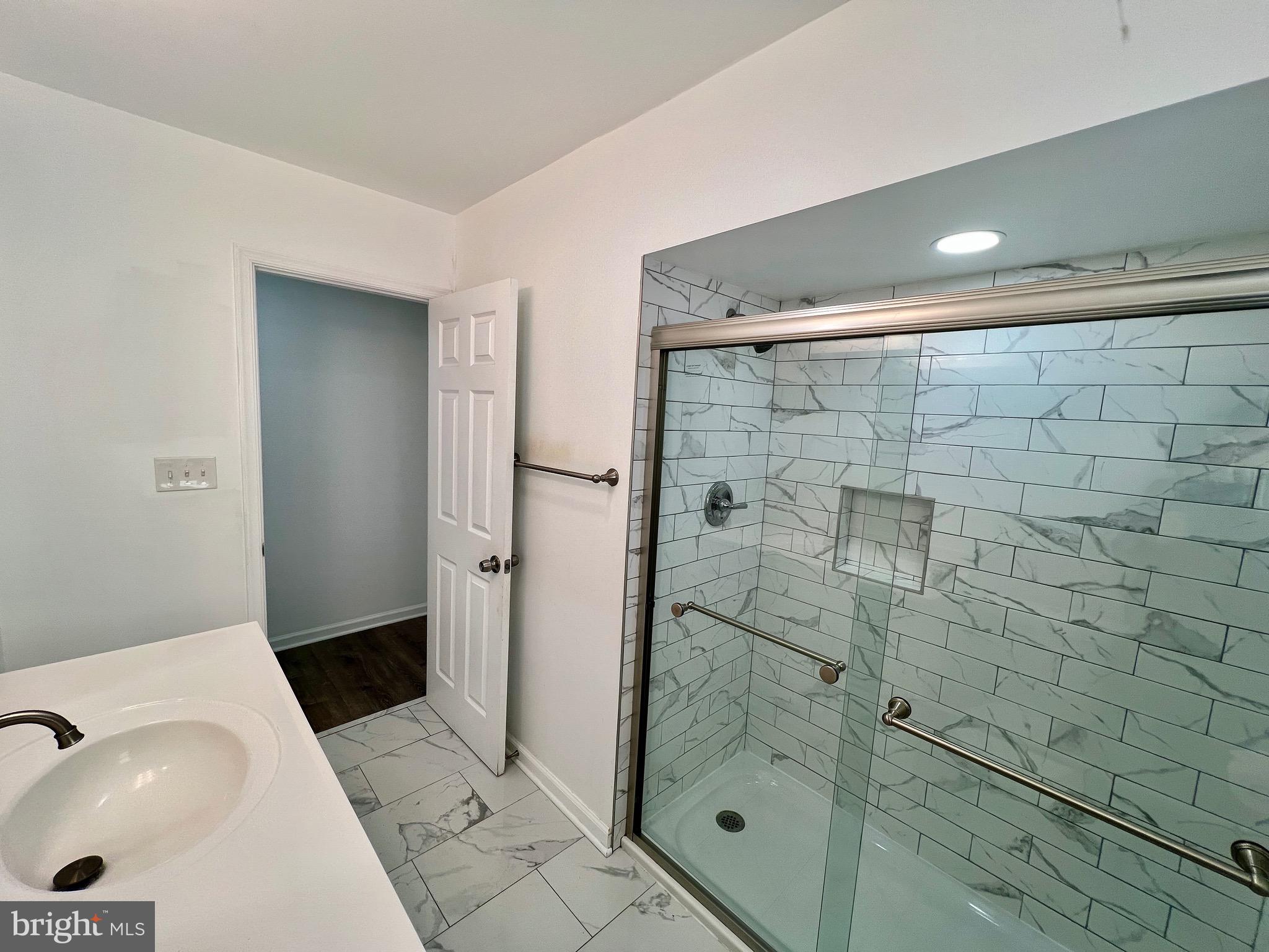 315 Shepherd Avenue Cambridge, MD 21613 - Photo 11 of 21 a bathroom with a shower and a sink