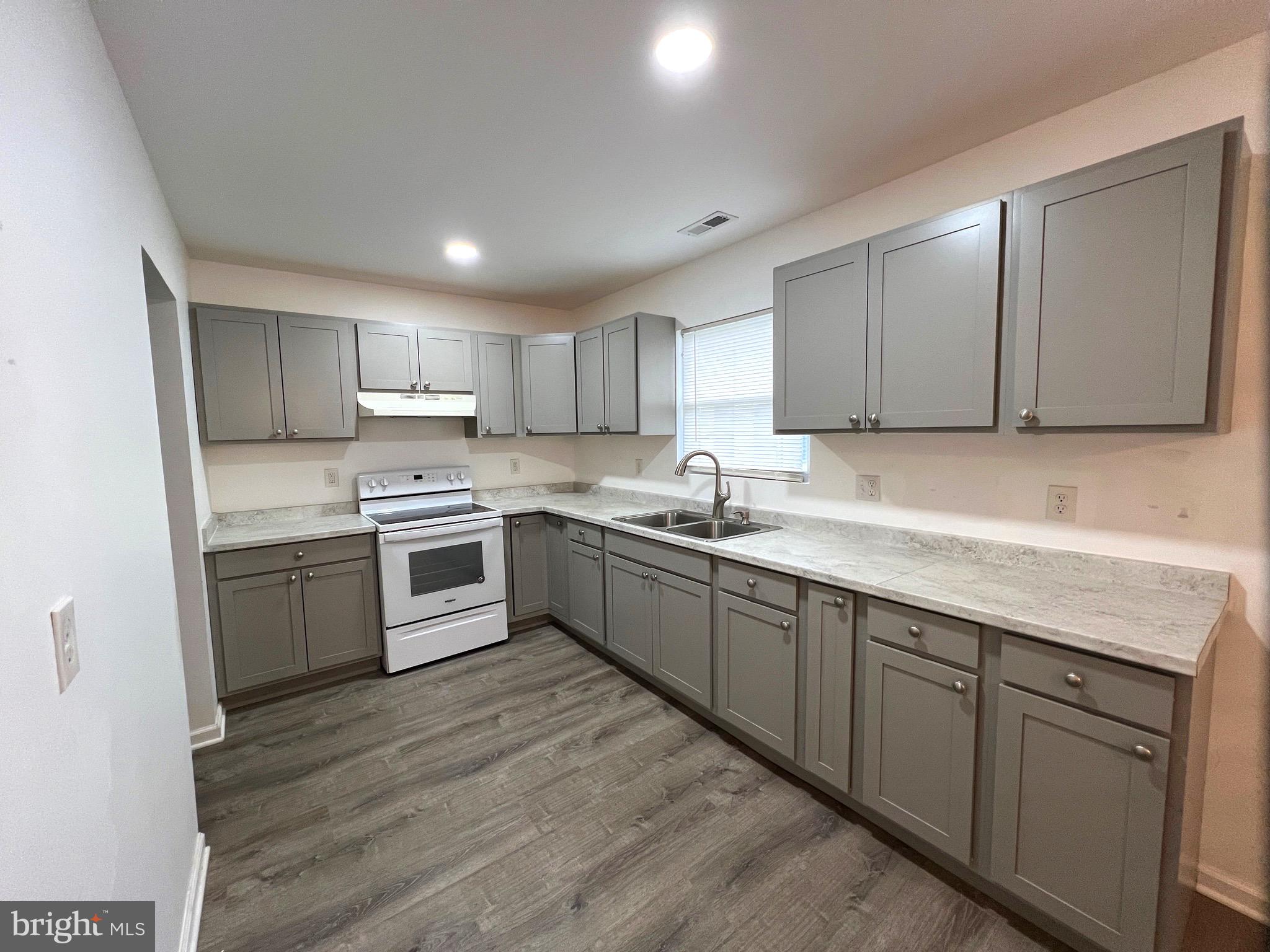 315 Shepherd Avenue Cambridge, MD 21613 - Photo 3 of 21 a kitchen with sink a microwave and cabinets