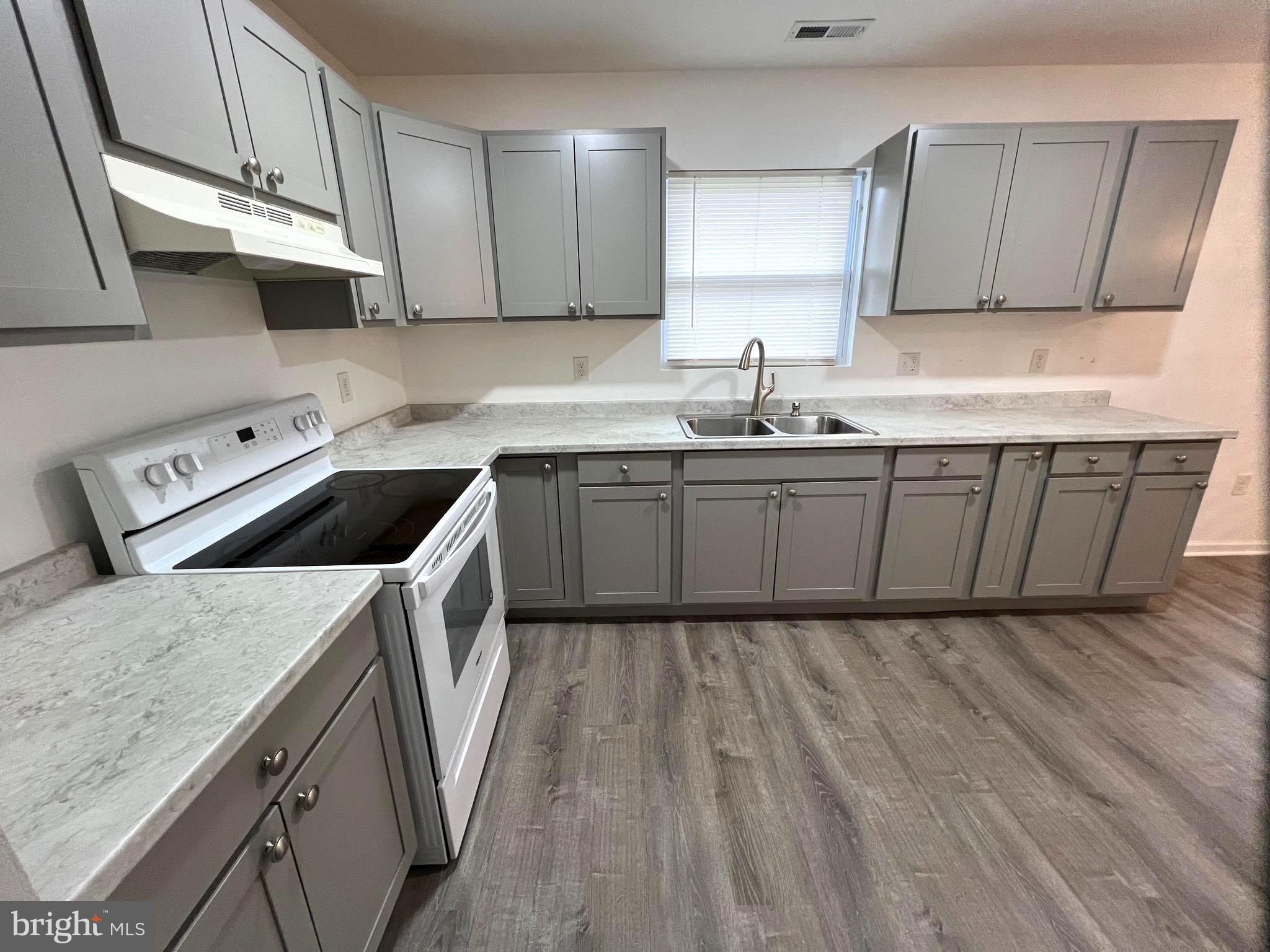 315 Shepherd Avenue Cambridge, MD 21613 - Photo 4 of 21 a kitchen with stainless steel appliances granite countertop a sink stove and cabinets