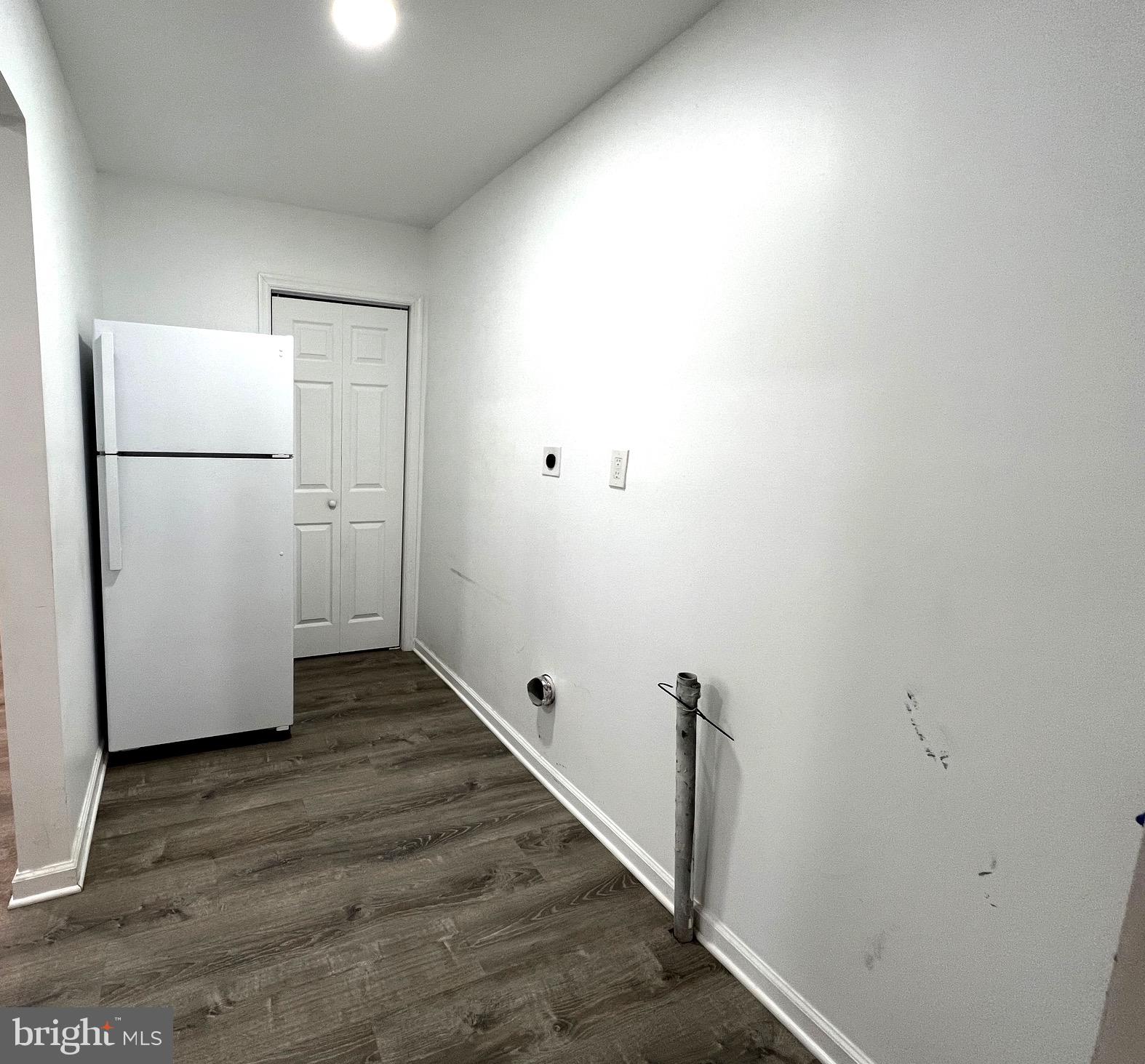 315 Shepherd Avenue Cambridge, MD 21613 - Photo 7 of 21 a view of a refrigerator in kitchen and white cabinets