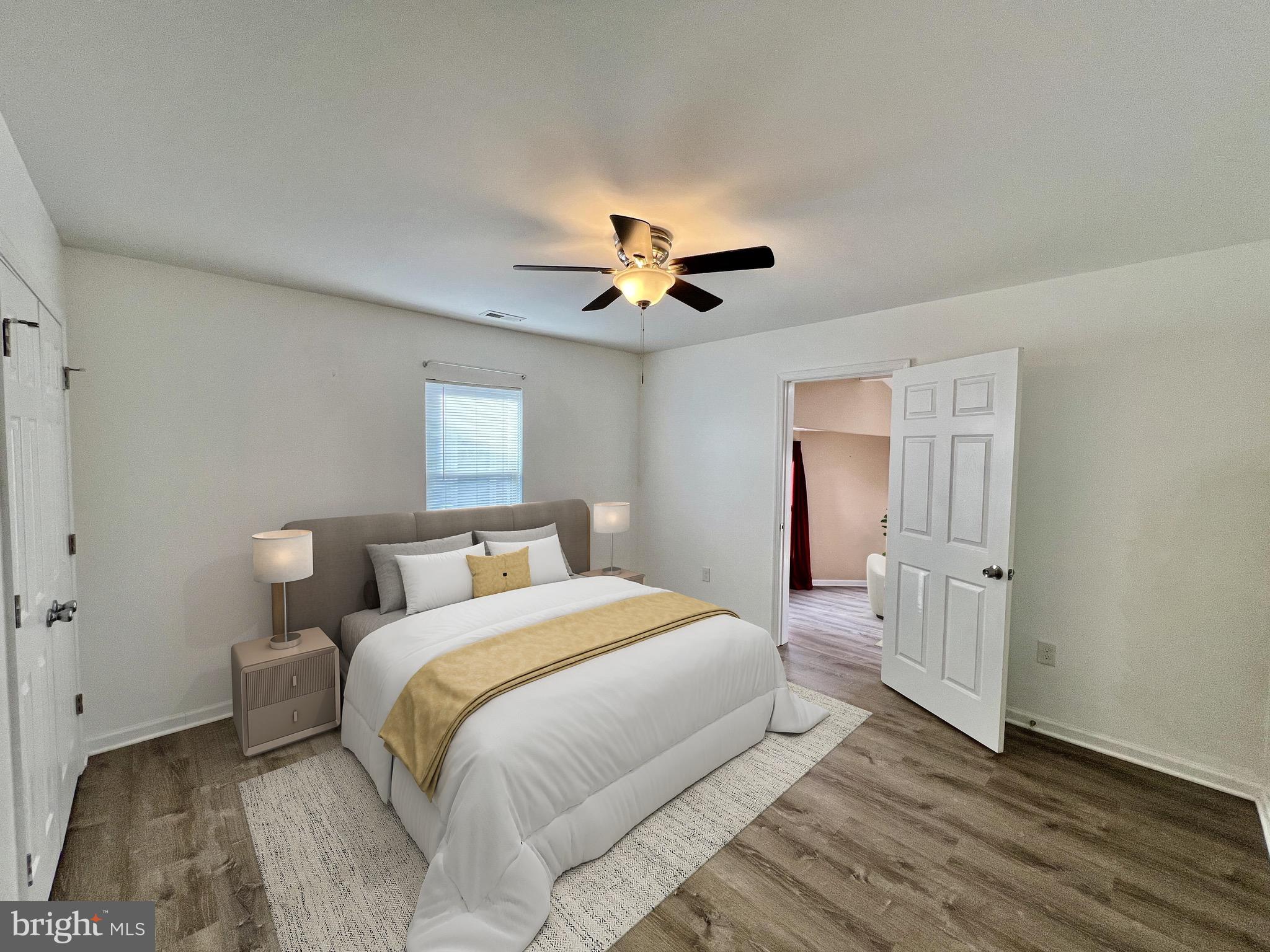 315 Shepherd Avenue Cambridge, MD 21613 - Photo 8 of 21 a bedroom with a bed and a chandelier