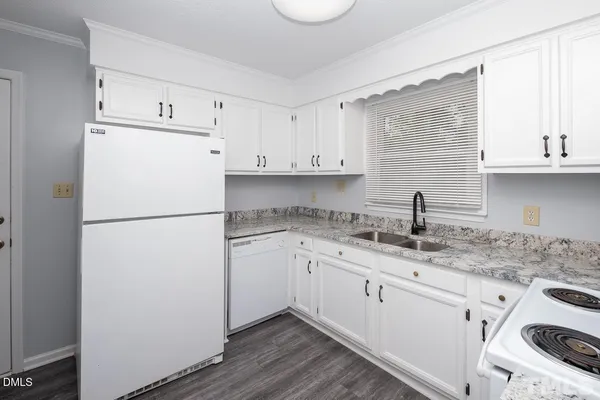 a kitchen with appliances cabinets and a sink