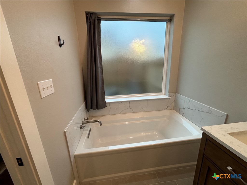 110 Hiram Cook Blanco, TX 78606 - Photo 45 of 46 a bathroom with a tub and a sink