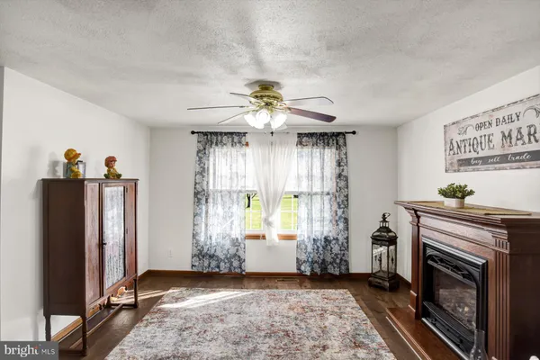 a living room with furniture large window and a fireplace
