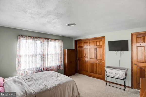 a bedroom with a bed and a piano in it