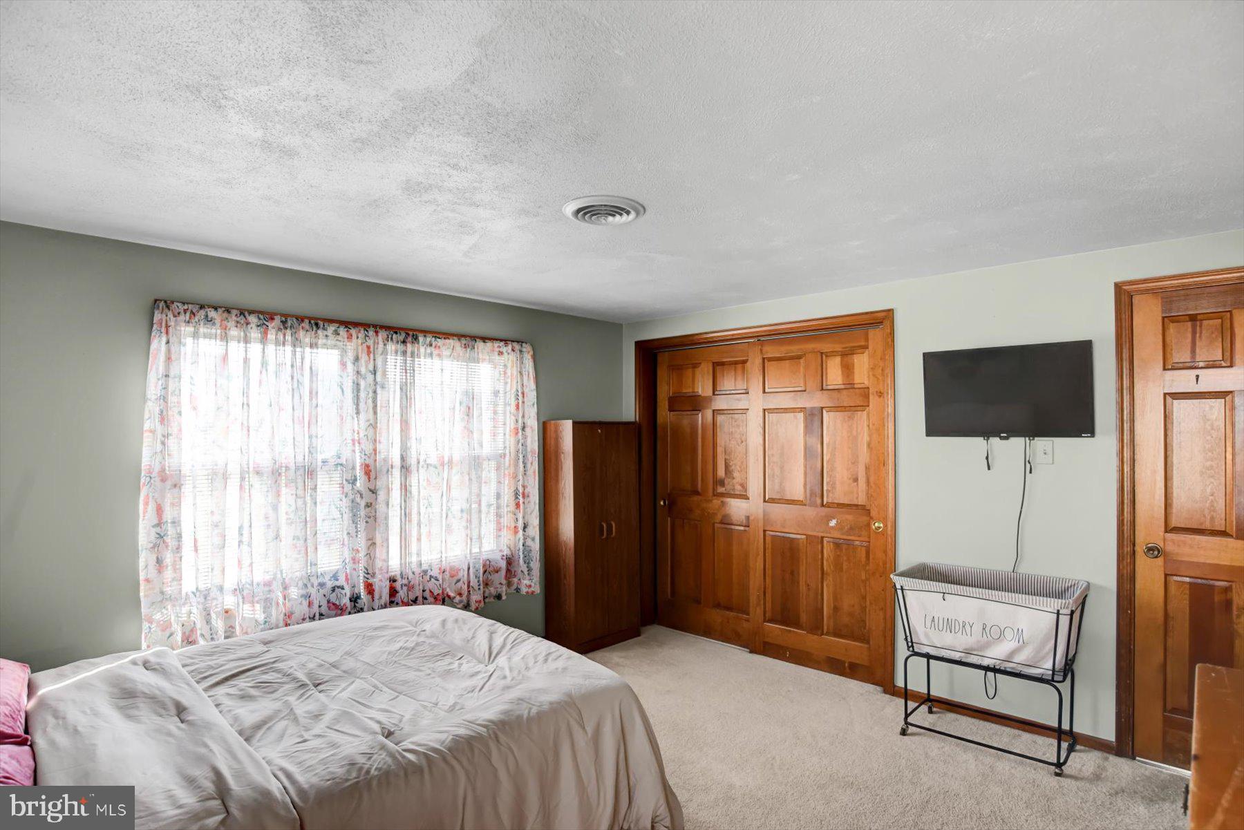 6 James Street Mill Hall, PA 17751 - Photo 22 of 39 a bedroom with a bed and a flat screen tv