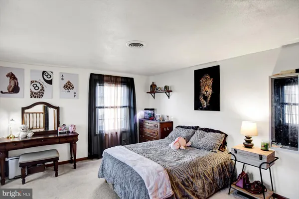 a bedroom with a large bed and a window