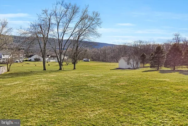 a view of open space with trees in the background
