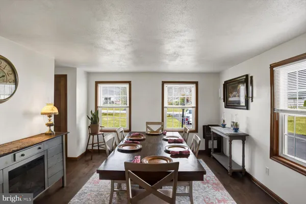 a view of a kitchen with furniture wooden floor and a ceiling fan