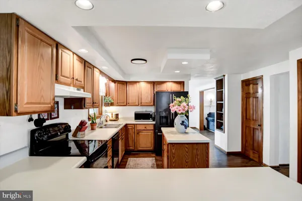 a open kitchen with stainless steel appliances granite countertop a sink stove and refrigerator