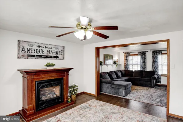 a view of a livingroom with a fireplace window and wooden floor