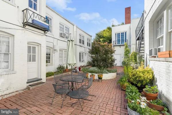 a view of a patio with couches and potted plants