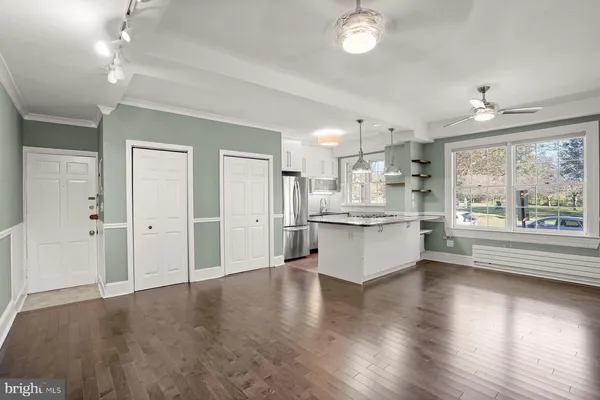 a large kitchen with a large window appliances and cabinets