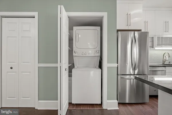 a view of kitchen with furniture and refrigerator