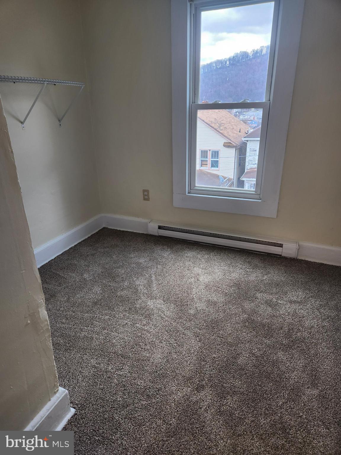 122 Spring Street, Unit B Keyser, WV 26726 - Photo 6 of 8 an empty room with a window