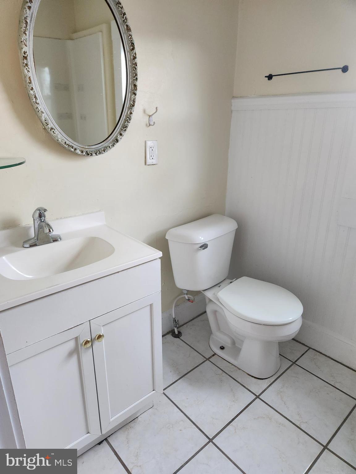 122 Spring Street, Unit B Keyser, WV 26726 - Photo 7 of 8 a bathroom with a toilet sink and mirror