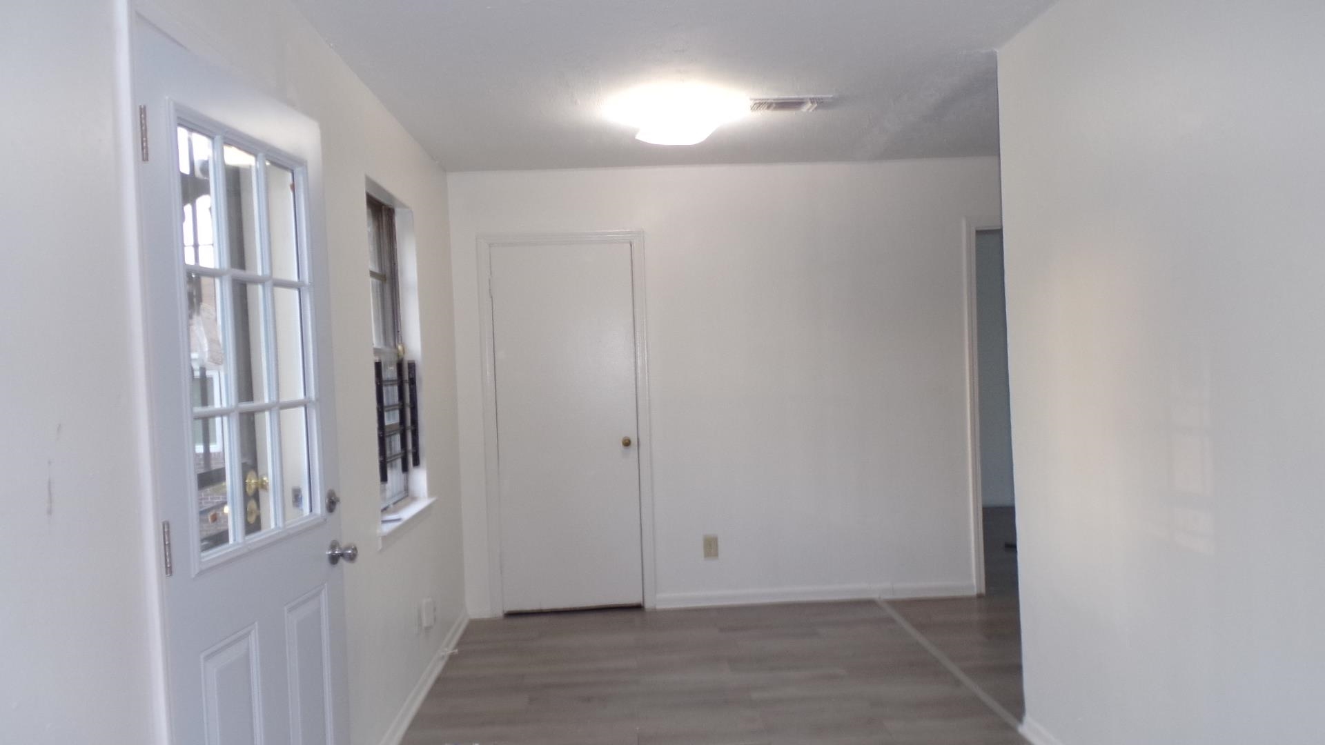 5057 Gill Road Memphis, TN 38109 - Photo 6 of 11 a view of a hallway with wooden floor and entryway