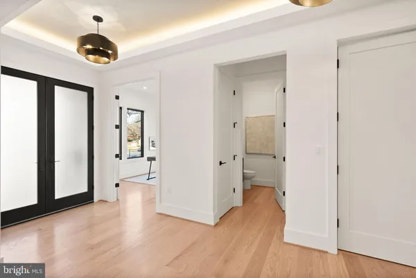 a bedroom with a bed and large window with balcony view