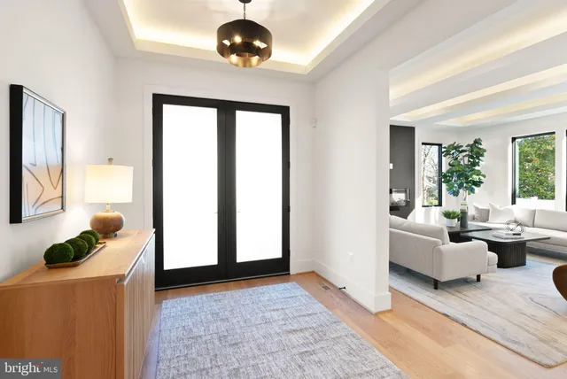 a spacious bedroom with a bed and a chandelier