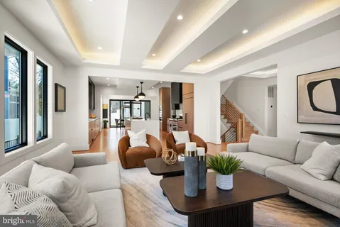 a spacious bedroom with a large bed a chandelier and closet