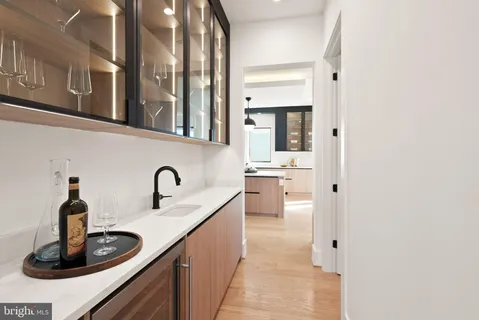 a view of a hallway with furniture and wooden floor