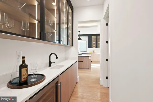 a view of a hallway with furniture and wooden floor