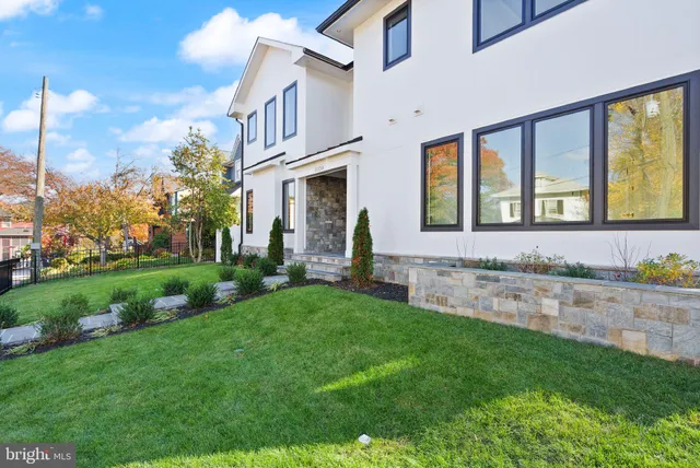 a view of a house with a yard and pathway