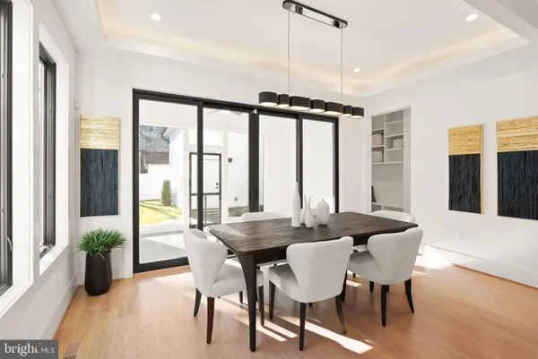 a dining room with furniture and wooden floor