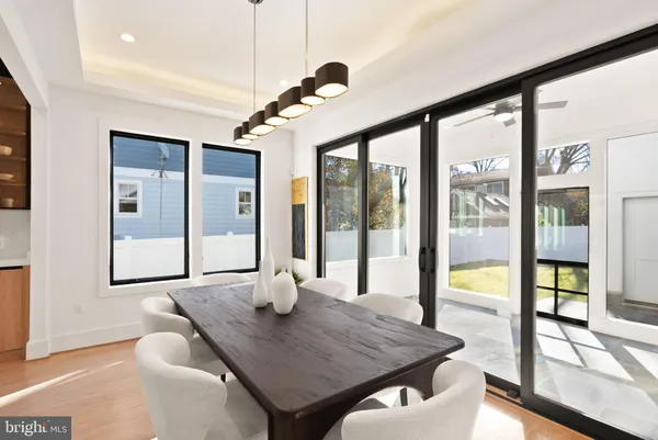 a living room with furniture a flat screen tv and a large window