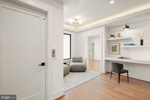 a living room with furniture a flat screen tv and a large window