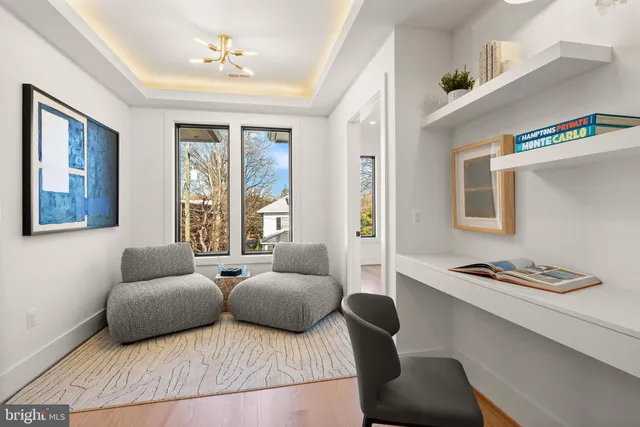 a living room with furniture potted plant and a flat screen tv