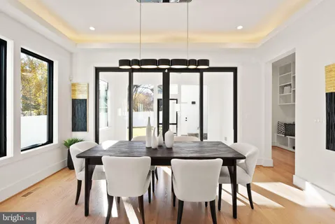 a living room with furniture and large windows