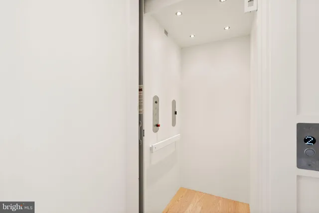 a view of a hallway with white walls