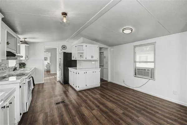 a kitchen with stainless steel appliances a refrigerator and a stove top oven