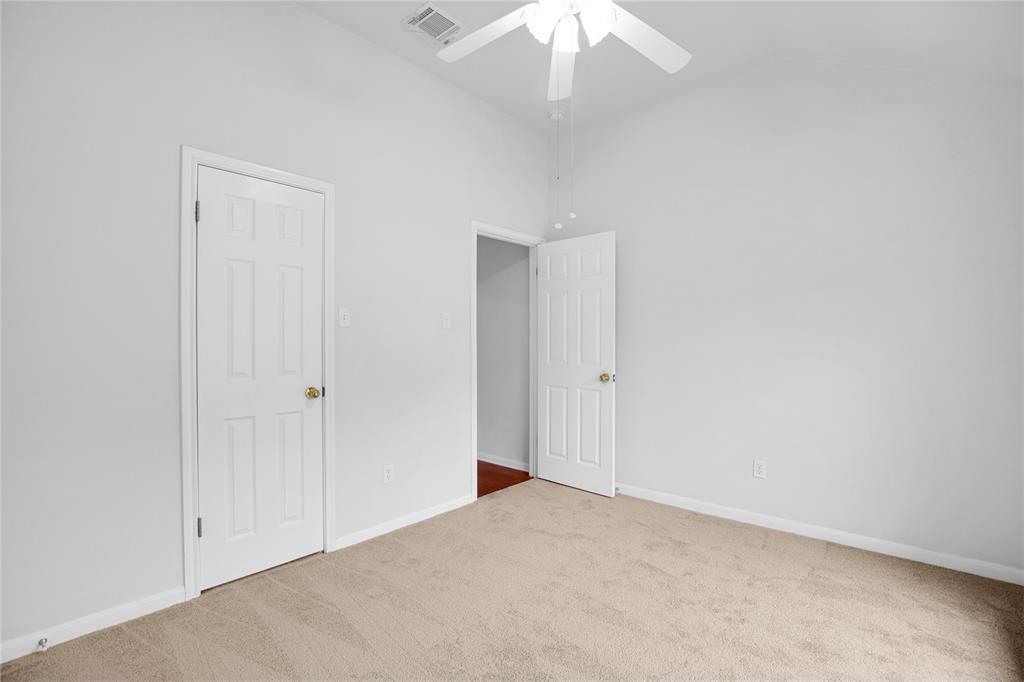 281 Hutton Kyle, TX 78640 - Photo 30 of 37 A well-proportioned bedroom with a vaulted ceiling and a ceiling fan for comfort.