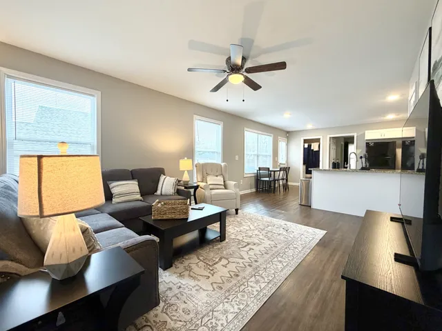 a living room with furniture and a flat screen tv